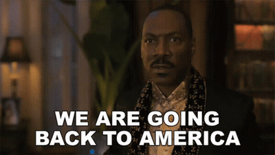 Man In Tuxedo And Scarf Says We Are Going Back To America GIF