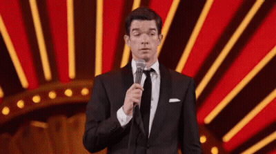 Man In Tuxedo And Tie Holding Microphone GIF