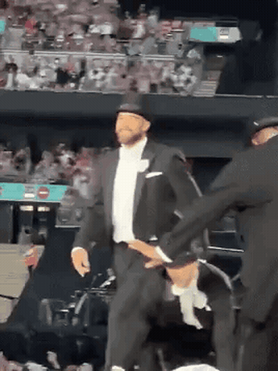 Man In Tuxedo And Top Hat Dancing Before Crowd GIF