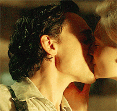 Man In Tuxedo And Woman In Black Dress Kissing GIF