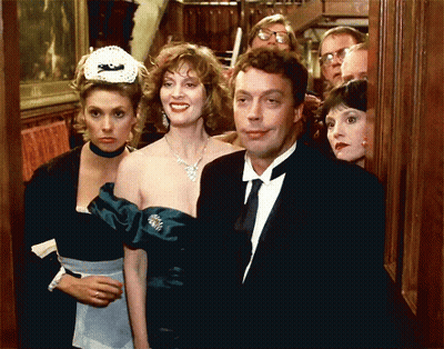 Man In Tuxedo And Woman In Maid Outfit Standing Together GIF