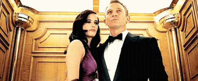 Man In Tuxedo And Woman In Purple Dress GIF