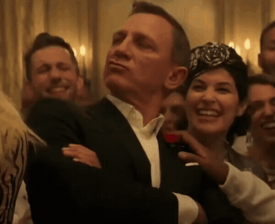 Man In Tuxedo And Woman In Turban GIF