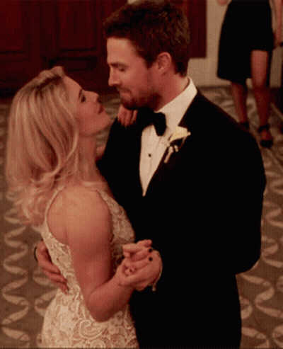 Man In Tuxedo And Woman In White Dress Dancing GIF