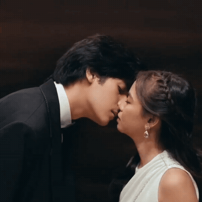 Man In Tuxedo And Woman In White Dress Kissing GIF