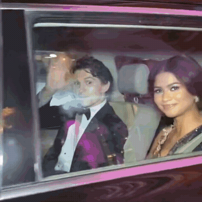 Man In Tuxedo And Woman Woman In Dress Sitting In Car GIF