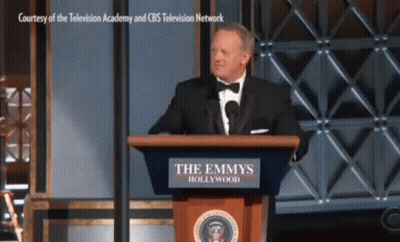 Man In Tuxedo At Emmys Podium GIF