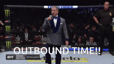 Man In Tuxedo At Microphone With Outbound Time GIF