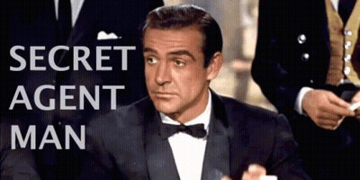 Man In Tuxedo At Secret Agent Man Sign GIF