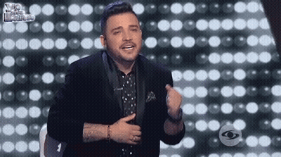 Man In Tuxedo Before Wall Of Lights GIF