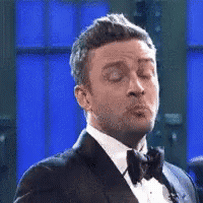 Man In Tuxedo Blowing Kiss Eyes Closed GIF