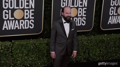 Man In Tuxedo By Golden Globe Awards Wall GIF