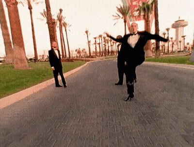 Man In Tuxedo Dancing On Brick Road GIF