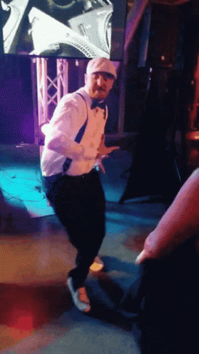 Man In Tuxedo Dancing On Stage GIF