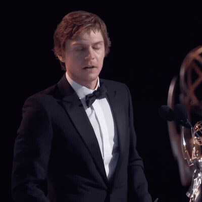 Man In Tuxedo Giving Speech At Two Microphones GIF