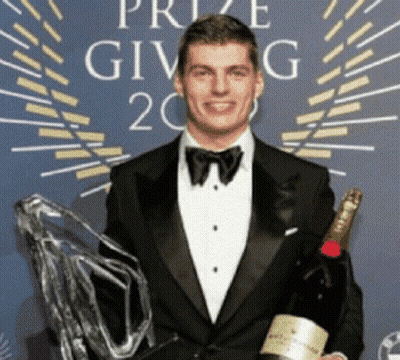 Man In Tuxedo Holding Champagne GIF