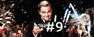 Man In Tuxedo Holding Champagne Glass With Number 9 GIF
