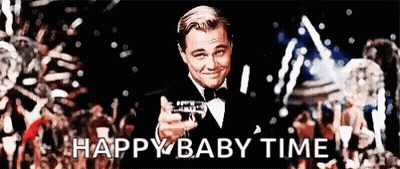 Man In Tuxedo Holding Champagne In Front Of Crowd GIF