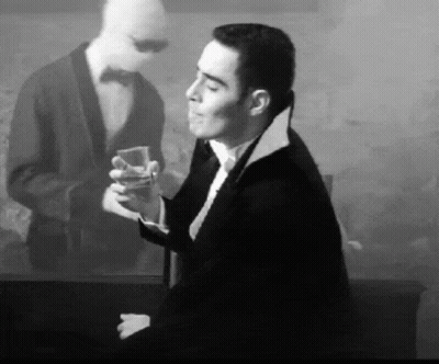 Man In Tuxedo Holding Drink GIF