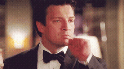 Man In Tuxedo Holding Fist Up GIF
