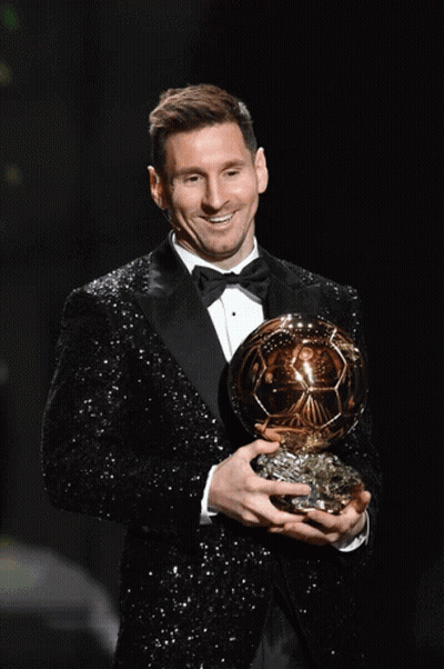 Man In Tuxedo Holding Gold Ball GIF