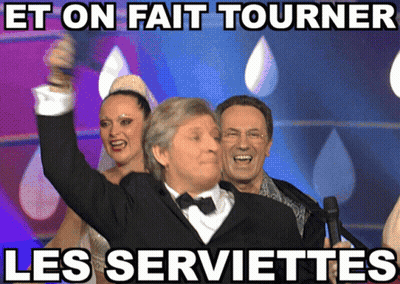 Man In Tuxedo Holding Microphone Et On Fait Tourner Les Serviettes GIF
