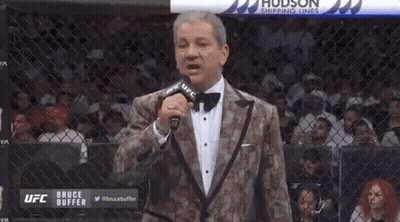 Man In Tuxedo Holding Microphone GIF