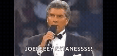 Man In Tuxedo Holding Microphone Saying Joeeeey Estanesss GIF