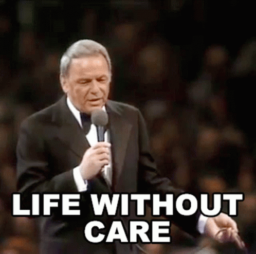 Man In Tuxedo Holding Microphone With Life Without Care GIF