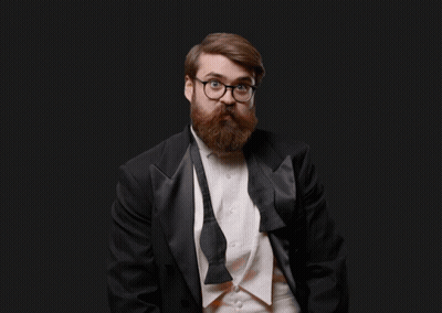 Man In Tuxedo Holding Orange Pumpkin GIF