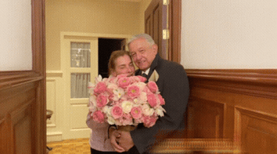 Man In Tuxedo Holding Pink Bouquet GIF