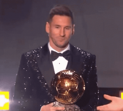 Man In Tuxedo Holding Soccer Ball GIF