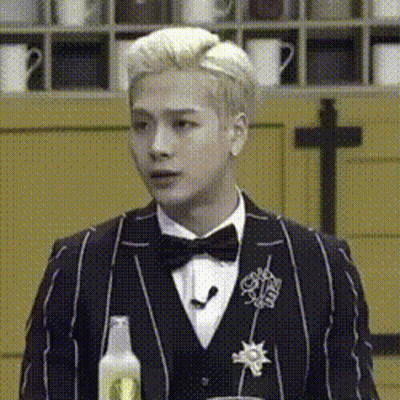 Man In Tuxedo Holding Soda Bottle GIF