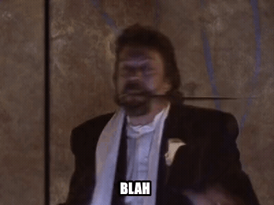 Man In Tuxedo Holding Sword In Mouth Saying Blah GIF