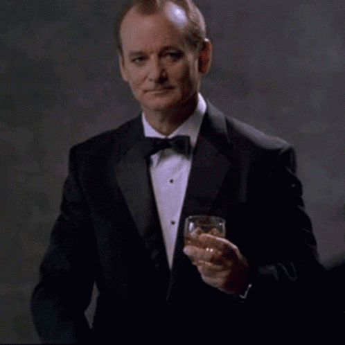 Man In Tuxedo Holding Whiskey Says Youre Welcome GIF