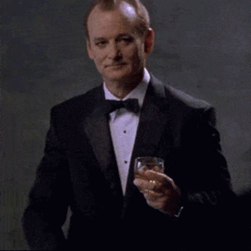 Man In Tuxedo Holding Whiskey GIF