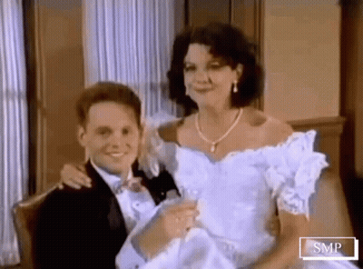 Man In Tuxedo Holding Woman In Wedding Dress GIF