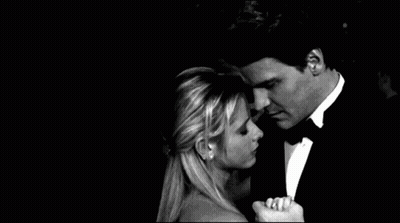 Man In Tuxedo Hugging Woman In Dress At Party GIF