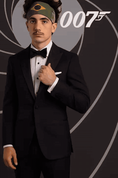Man In Tuxedo In Front Of 007 Sign GIF