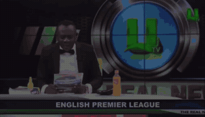 Man In Tuxedo In Front Of English Premier League Screen GIF