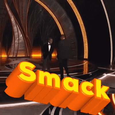 Man In Tuxedo In Front Of Orange Smack Sign GIF