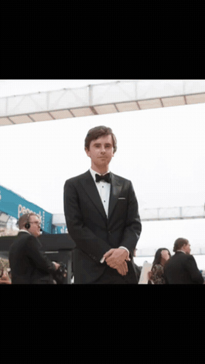 Man In Tuxedo In Front Of Pepsi Sign GIF