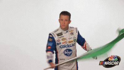 Man In Tuxedo In Front Of UI Sign GIF