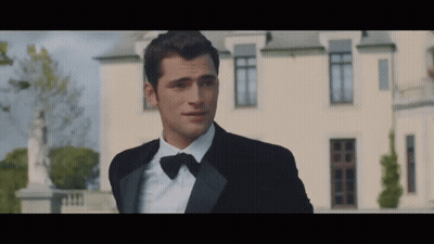 Man In Tuxedo In Front Of White Building GIF