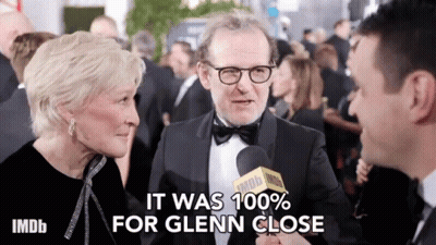 Man In Tuxedo Interviewed By Woman With IMDB Microphone GIF