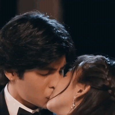 Man In Tuxedo Kissing Woman In Dress GIF