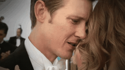 Man In Tuxedo Kissing Woman On Forehead GIF