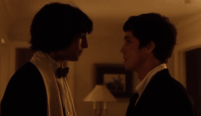 Man In Tuxedo Looking At Man In White Shirt GIF