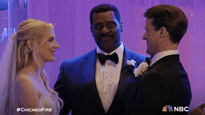 Man In Tuxedo Next To Bride And Groom With NBC Logo GIF