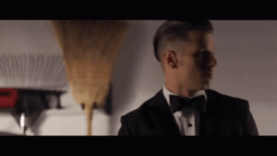 Man In Tuxedo Next To Broom GIF